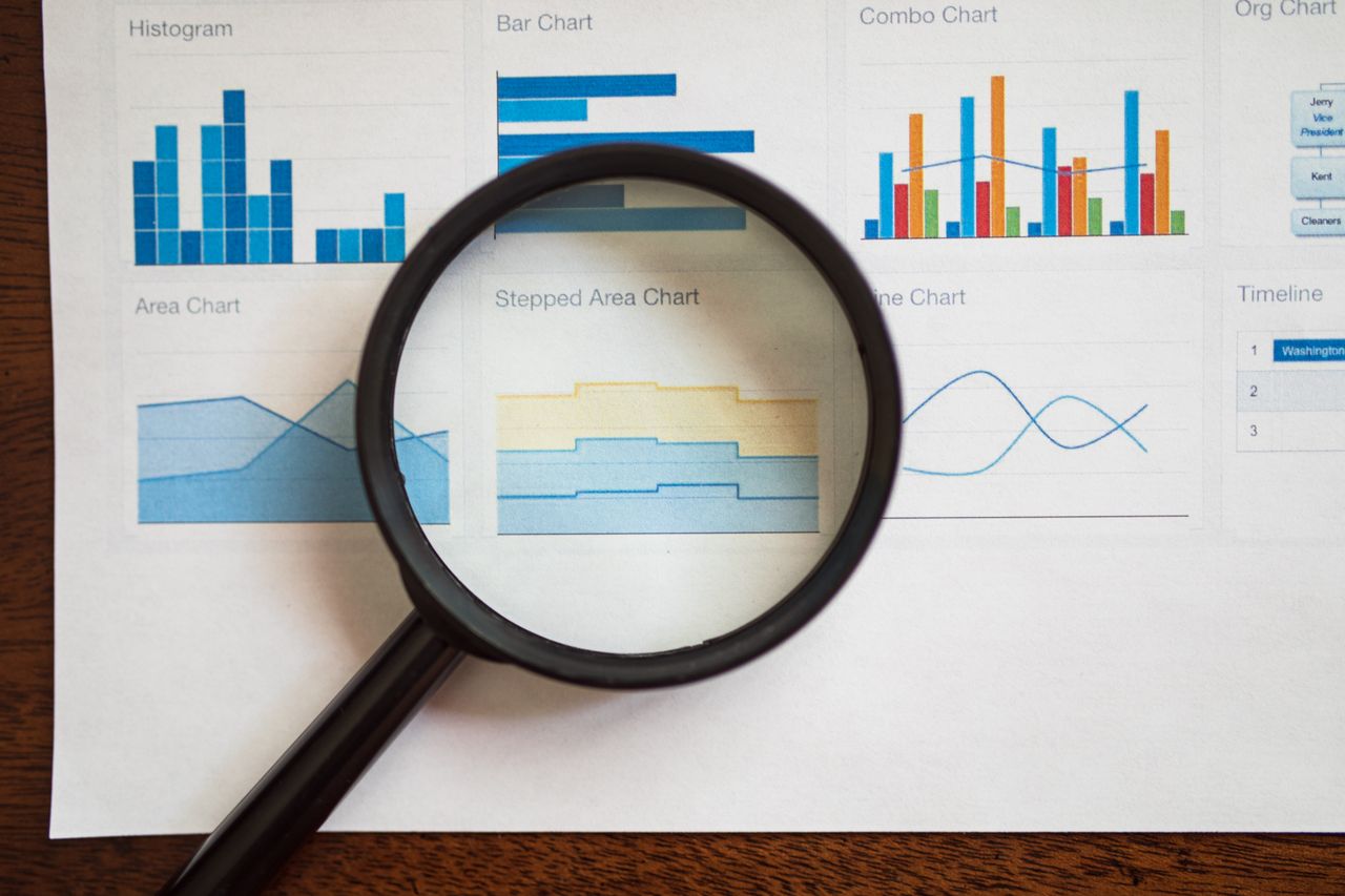 Magnifying glass reviewing SEO frequently asked questions