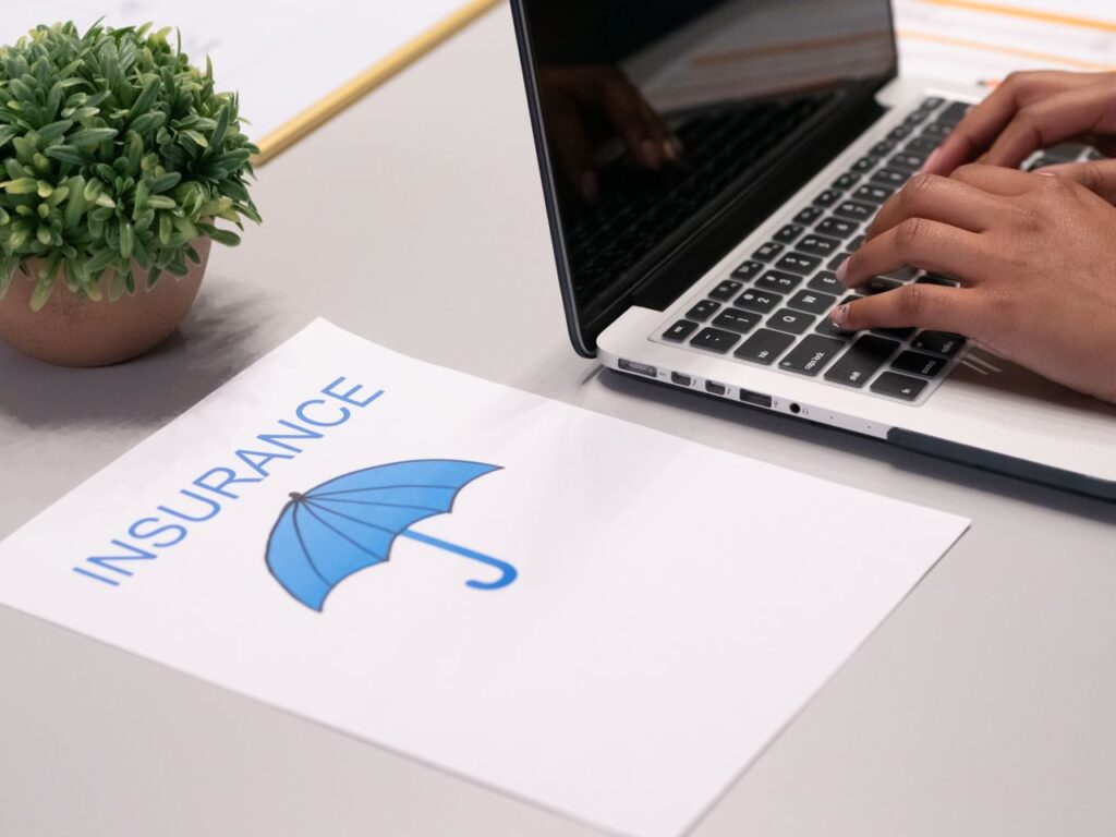 Healthcare staff verifying patient insurance eligibility on laptop