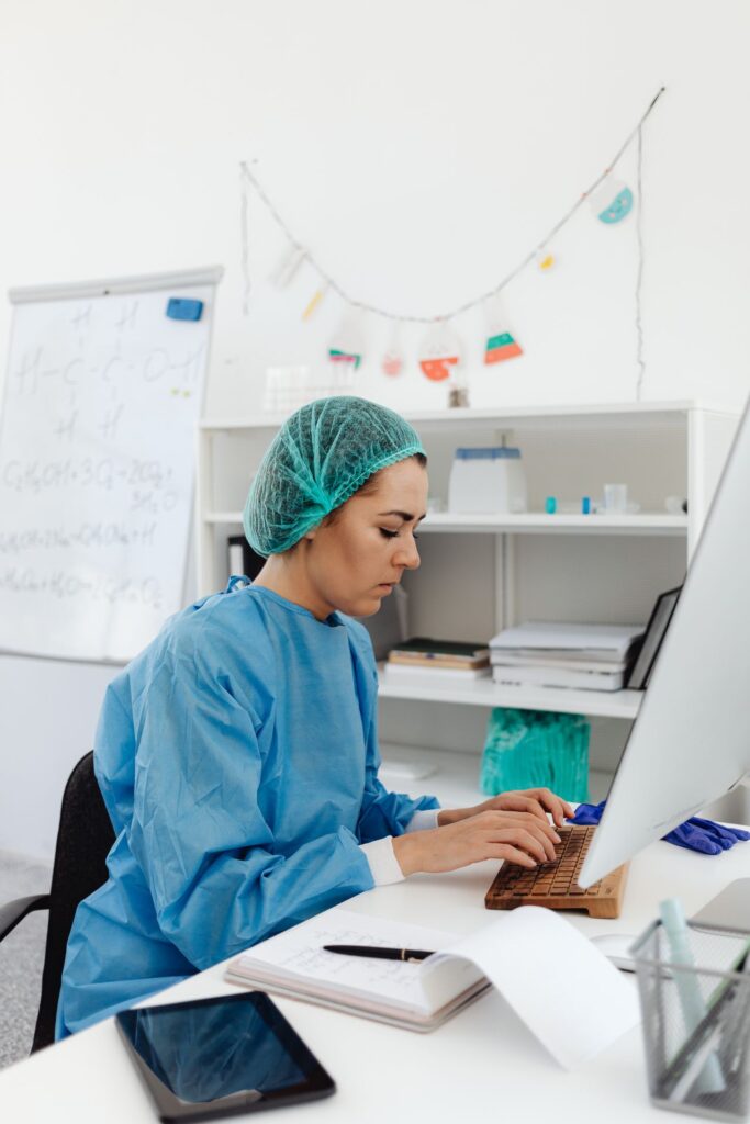 Healthcare professional performing medical coding on computer