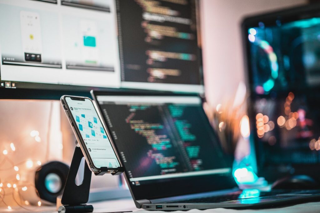 Developer working on custom website code across multiple screens